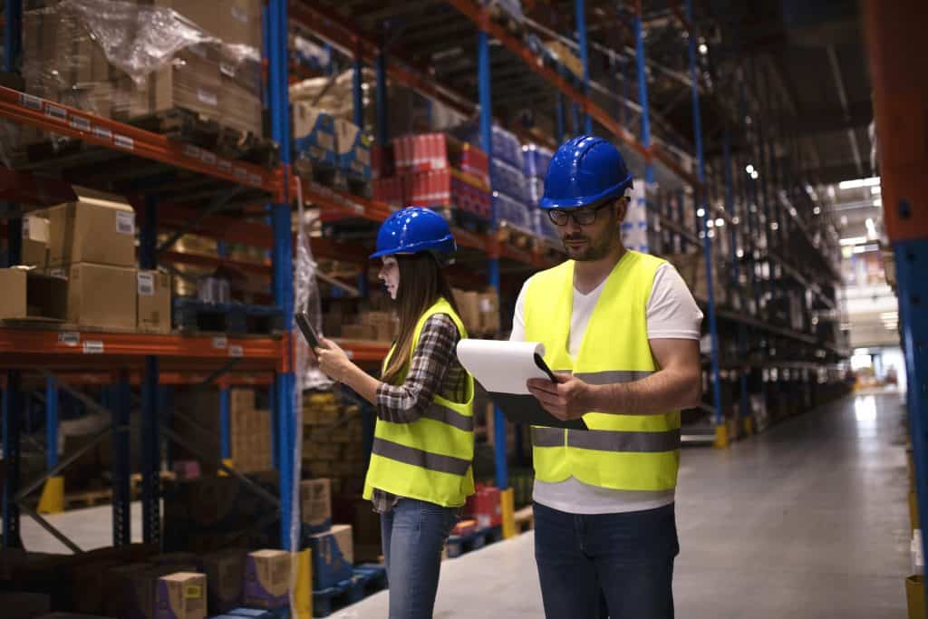 A training session in a warehouse, showing staff learning to use depth mapping equipment and software.