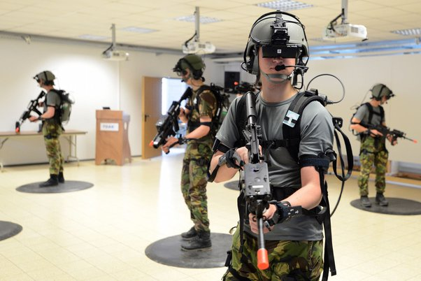 Soldiers using VR headsets in a simulated combat training environment.